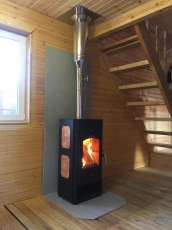 Популярный камин с дровницей Сибирь 8 в интерьере фото в Гродно