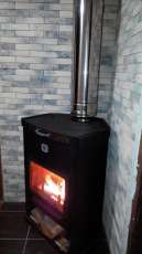 Стальной недорогой камин Теплодар ОВ-120 (угловой) фото в интерьере в Гродно