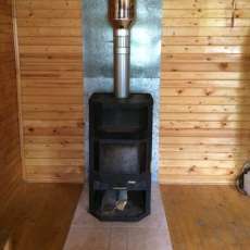 Печь-камин с шамотом Мета-Бел Ангара-Аква в интерьере фото в Гродно